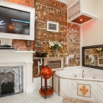 Mounted TV above the fireplace, and jacuzzi tub in the Fleur De Lis Suite.