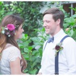 Bride and the groom looking into each other eyes in the garden.