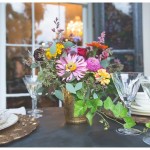 Colorful fall bouquet in gold vase on the table.