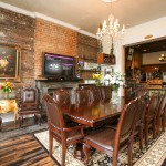 Dark brown large wood conference table and chairs in the Mardi Gras den.