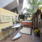 3 bar stools, glass bar in the back courtyard by hot tub.