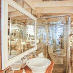 Side view of the vanity area, glass shower, and toilet in the Hollywood Bungalow.